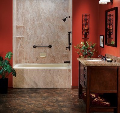 Bathroom with red walls, a brown marble tub and matching wall surrounds. 