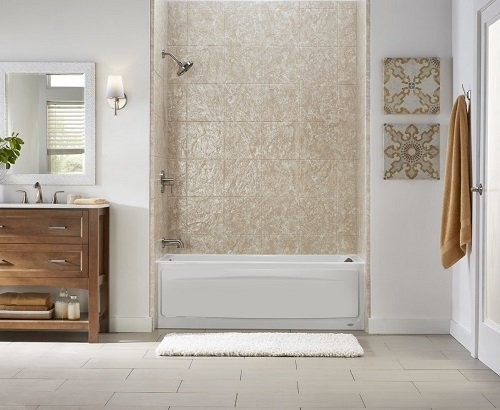 A large bathroom with a tub, wall surrounds, wood vanity, and tile floor. 