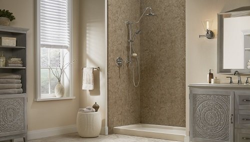 A bathroom with a walk-in shower, gray vanity, and beige walls. 